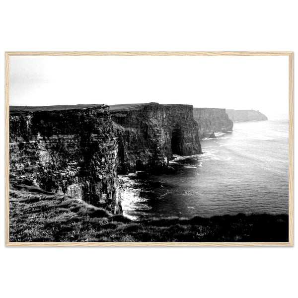 Monochrome photo of Cliffs of Moher, framed elegantly. Captures rugged beauty, contrasts. Minimalist frame complements decor. Evokes awe.