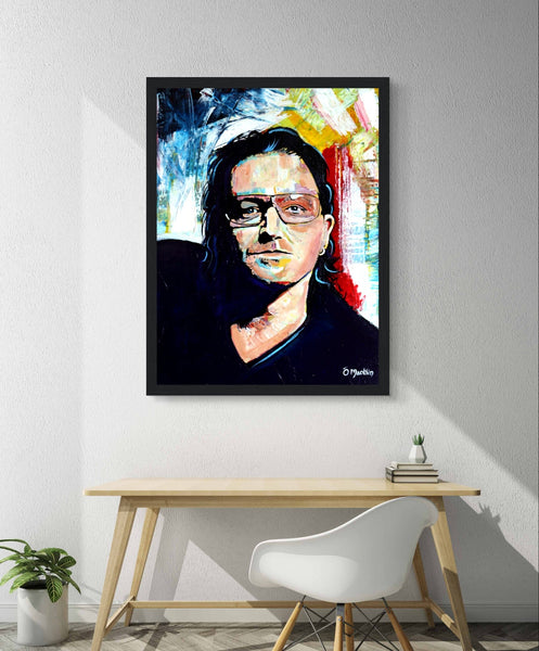 Framed wall art print of Bono from U2 by Irish artist Ó Maoláin. This vibrant, colorful portrait captures Bono's legendary stage presence with dynamic energy. Ideal for U2 fans, it blends rock 'n' roll flair and artistic expression, perfect for any decor.
