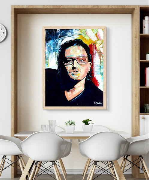 Vibrant, colorful framed portrait of Bono from U2 by Irish artist Ó Maoláin. Captures Bono's iconic stage presence, adding rock 'n' roll flair to any space. Perfect for U2 fans, this unique statement piece blends music and art in a bold, dynamic way.