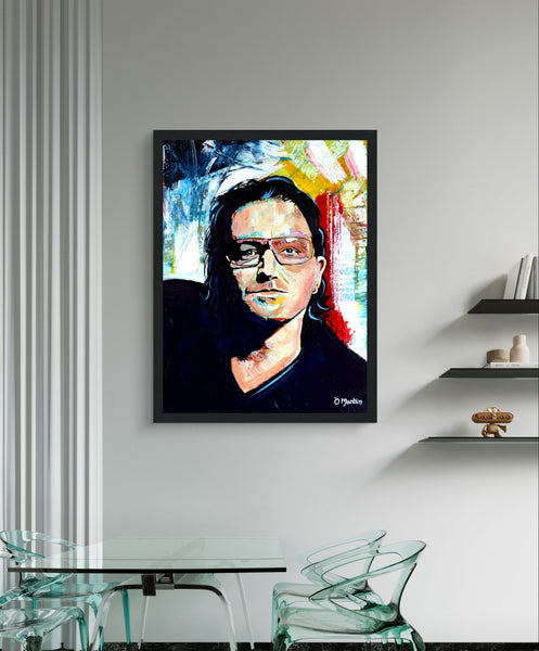 Vibrant, colorful framed wall art print of Bono from U2 by Irish artist Ó Maoláin. This portrait captures Bono's iconic stage presence, adding rock 'n' roll flair to your decor. Ideal for U2 fans, it blends music and art in a stunning statement piece.