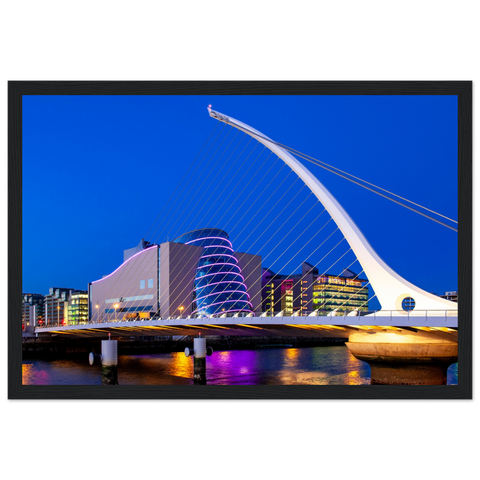 Framed art print featuring Dublin's illuminated Samuel Beckett Bridge and Convention Centre at night. Lights reflect on the River Liffey, capturing Dublin's magical skyline. Ideal for adding a touch of Irish charm to any room.