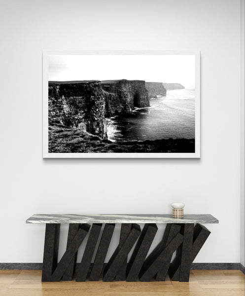 Monochrome photo: Cliffs of Moher. Dramatic landscape with rugged cliffs, crashing waves. Minimalist frame complements decor. Captivating for any space.
