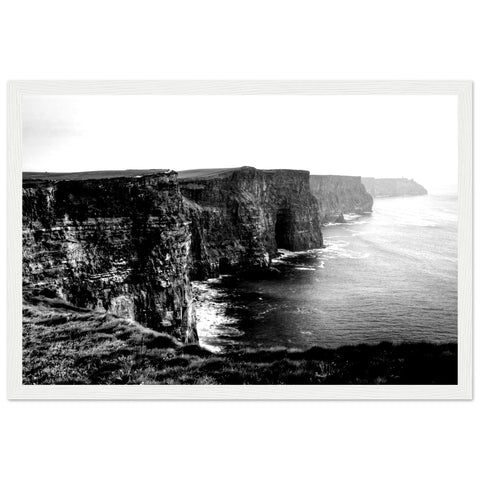 Monochrome photo of Cliffs of Moher, framed. Dramatic contrast emphasizes rugged beauty. Minimalist black frame complements any decor. Captivating for all.