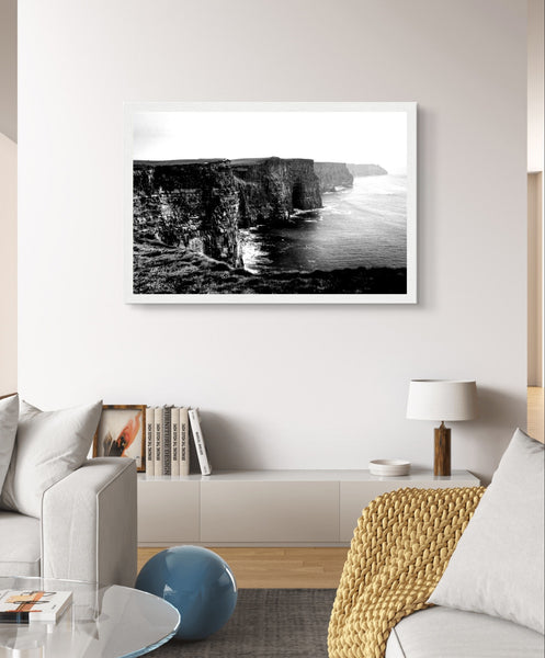Monochrome photo of Cliffs of Moher, framed elegantly. Captures rugged beauty, contrasts. Minimalist frame complements decor. Evokes awe.
