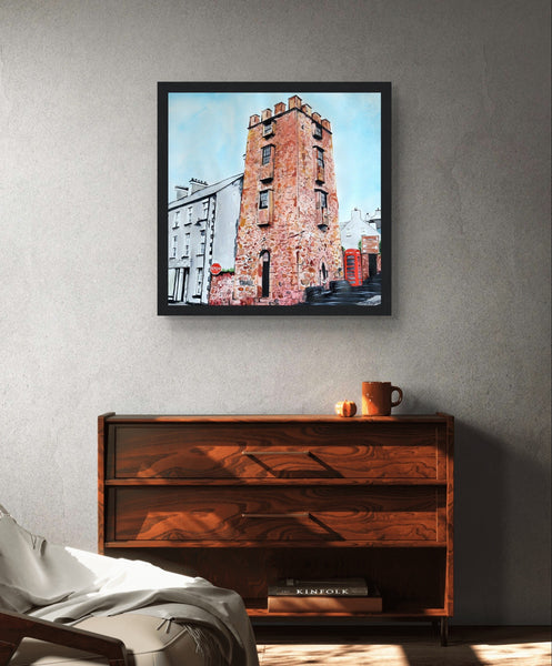 Framed art print The Curfew Tower by Ó Maoláin. This piece depicts The Curfew Tower in Cushendall, Glens of Antrim, built by Francis Turnley in 1820 and now owned by Bill Drummond. The artwork showcases the tower amid the scenic Glens of Antrim.