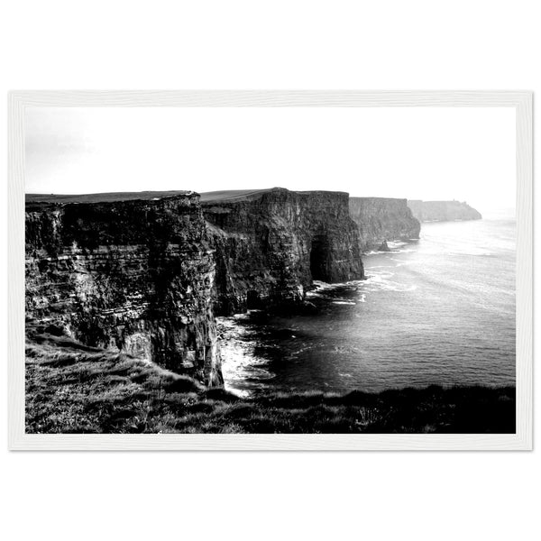 "Monochrome photo of Cliffs of Moher, framed elegantly. Captures rugged beauty, contrasts. Minimalist frame complements decor. Evokes awe.