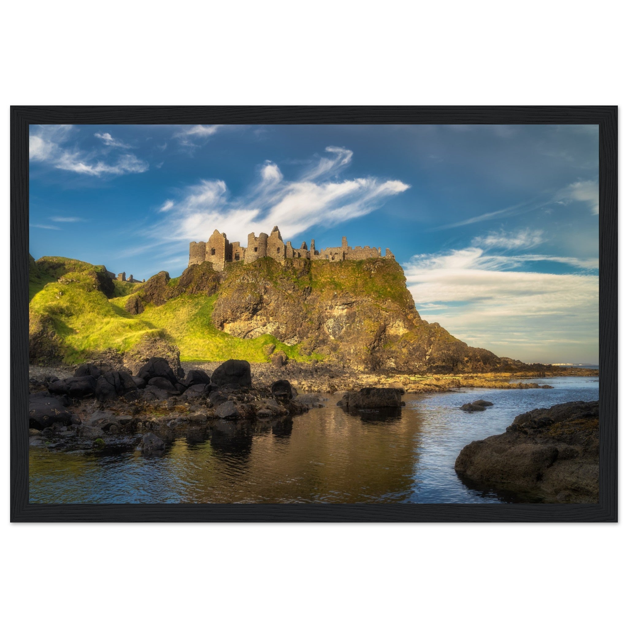 e65f02ae-a771-4813-8573-7cb3626b648dFramed wall art print of Dunluce Castle, showcasing its majestic ruins perched on a rugged cliff overlooking the sea. The detailed image captures the historic architecture and breathtaking coastal scenery, perfect for adding a touch of history and beauty to any room.